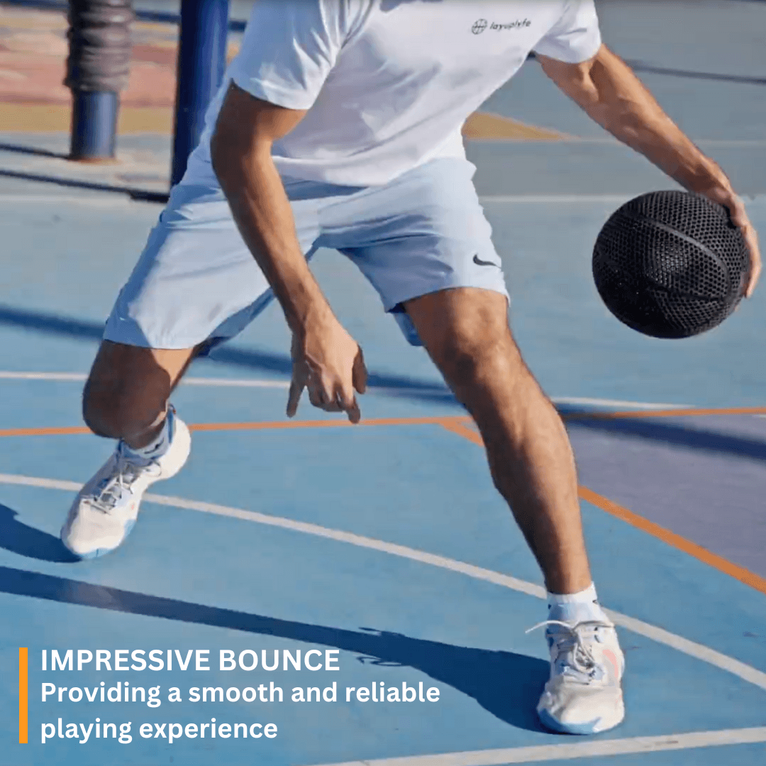 Man dribbling a 3D printed airless basketball on a court, showcasing impressive bounce and performance.
